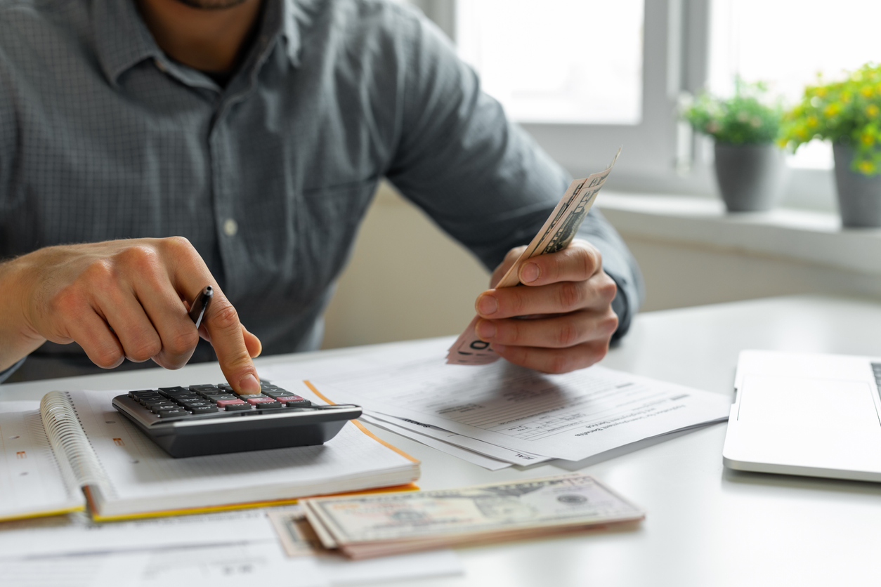 man-using-calculator-for-taxes